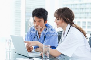stock photo 32192950 nurse explaining an application on the computer to her colleague